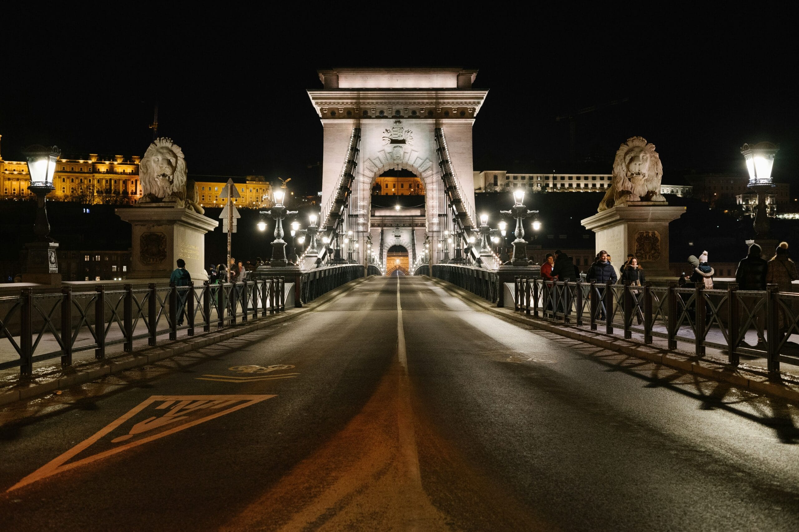 Stone lions and arches of the Chain Bridge in Budapest at night