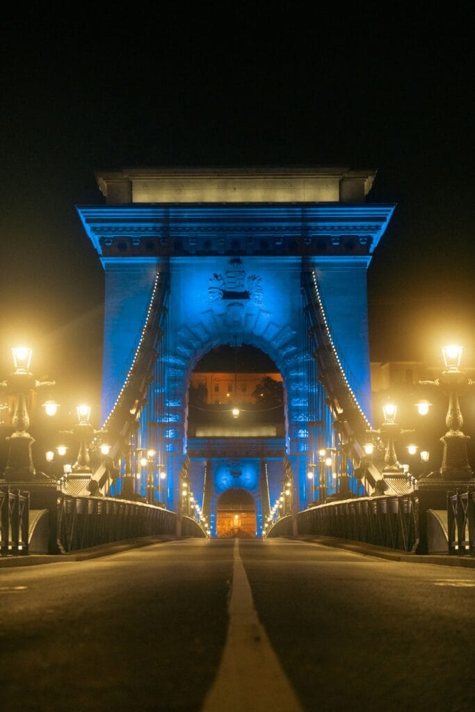 The Chain Bridge in Budapest illuminated at night, viewed from the center of the bridge